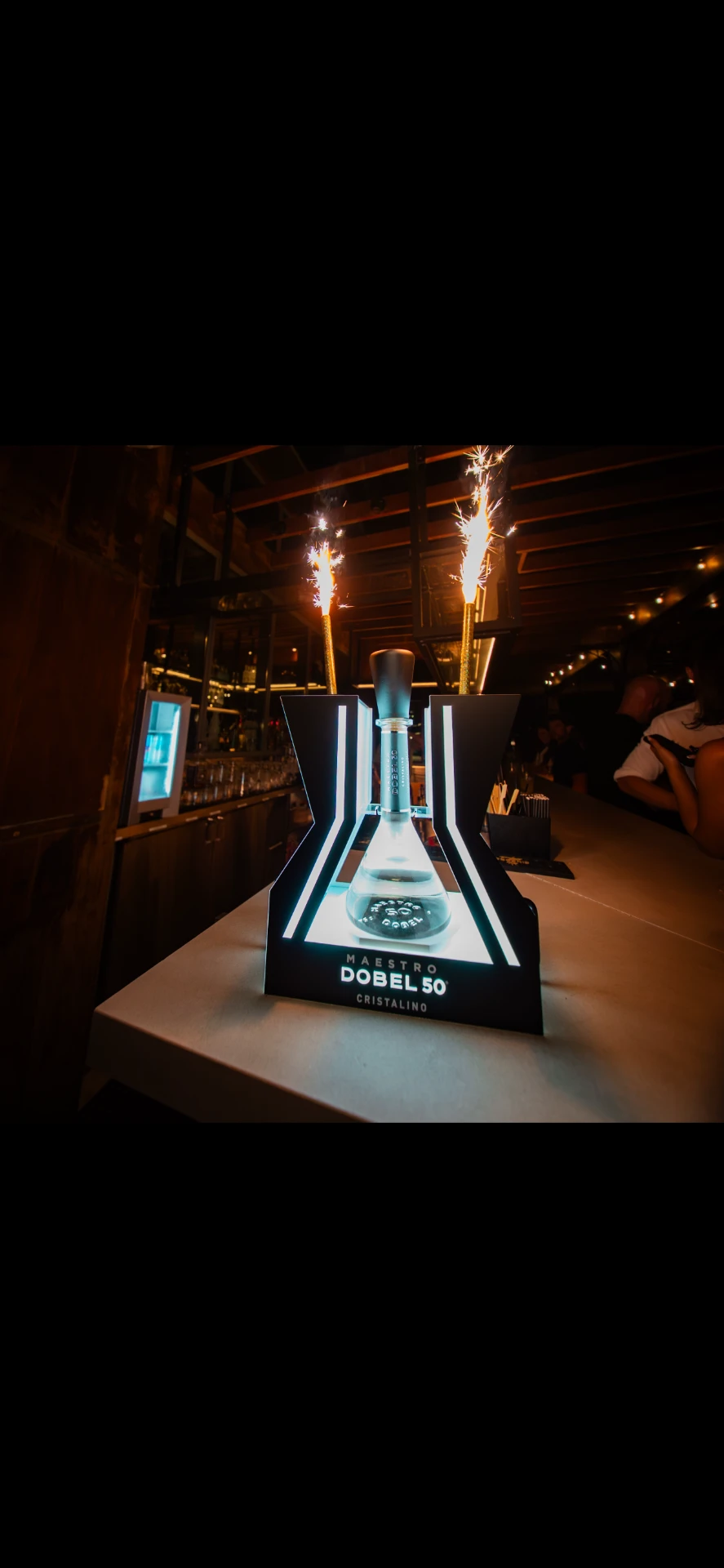 Branded tequila bottle activation with sparklers at a Broken Sound Records event
